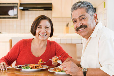 Good mood foods. Image of couple eating dinner.