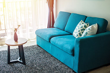 Living room with blue claming sofa.