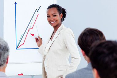 Image of women giving a business proposal in front of co-workers. Image of women giving a business proposal in front of co-workers.