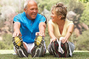 Image of an older couple stretching before a workout.