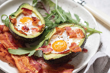 Image of avocado stuffed with eggs and bacon. Image of avocado stuffed with eggs and bacon.