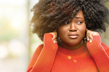 Women covering her ears with her fingers.