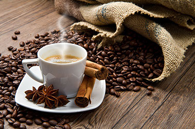 Image of a cup of coffee and coffee beans.