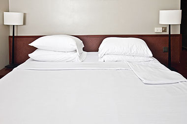 Avoid bed bugs. Image of a bed.