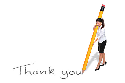 Concept image of women writing 'Thank you' with an oversized pencil.
