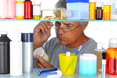 Bad medicine-the probelm with expired medications. Image of man going through the medicine cabinet.