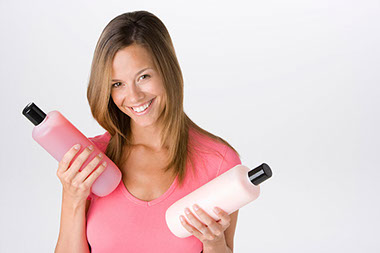 Image of women holding shampoo bottles. Image of women holding shampoo bottles.
