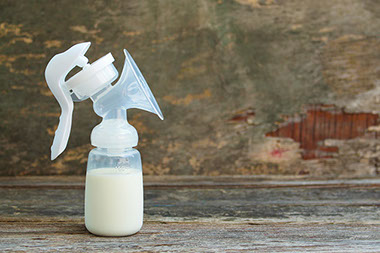 Breast pump bottle filled with milk.