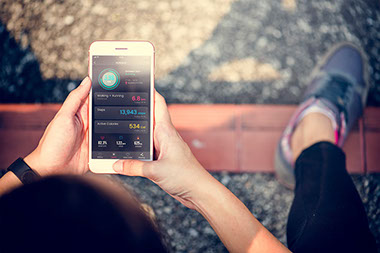 Person using digital device to track fitness and calories.