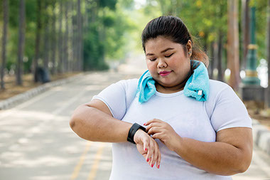 Women looking at watch before exercising. Women looking at watch before exercising.