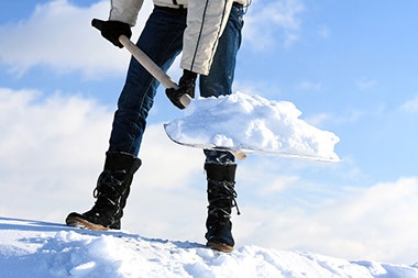 Image of a person shoveling snow.