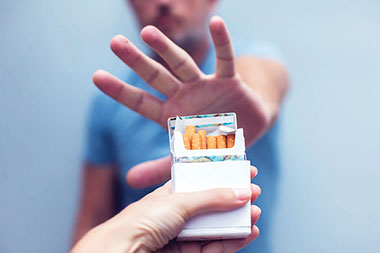 A hand offering cigarettes and another hand rejected them.