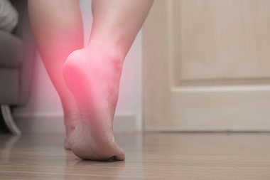 Image of heel walking on bare floor.