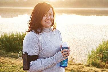 Smiling women ready to exercise, holding a water bottle. Smiling women ready to exercise, holding a water bottle.