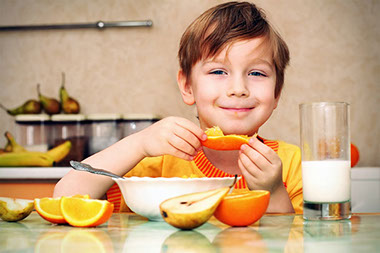 Image of young boy eating oranges. Image of young boy eating oranges.