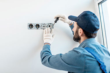 Electrician wearing gloves while working.