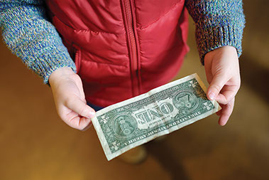 Child hands holding a dollar bill. Child hands holding a dollar bill.