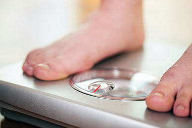 Image of feet on a scale. Image of feet on a scale.