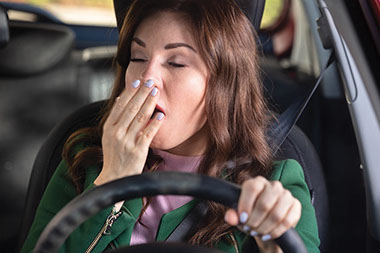 Women yawning while driving.