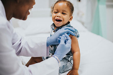 Young child getting a vaccine from doctor. Young child getting a vaccine from doctor.