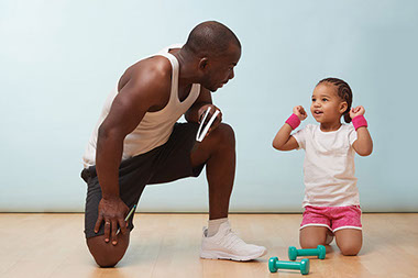 Father and young daughter about to exercise. Father and young daughter about to exercise.