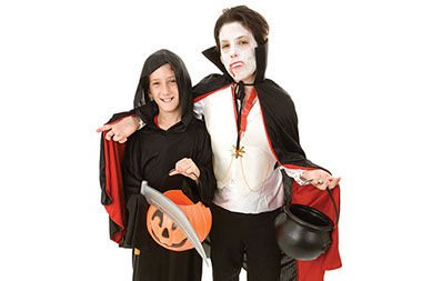 Image of a brother and sister dressed for Halloween.