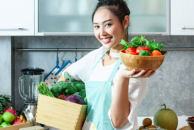 Women in kitchen with healthy foods.