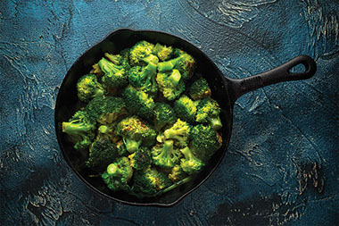 Large skillet filled with broccoli. Large skillet filled with broccoli.