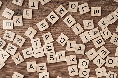 Wooden blocks with letters on wooden table.