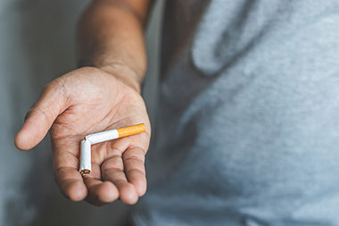 Broken cigarette in man's hand.