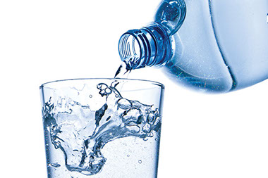 Hot-weather problems to avoid. Image of a water bottle being poured into a glass.