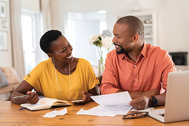 Couple smiling going over budget.