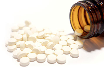 Image of a pill bottle with pills spilled out.