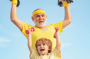 Grandfather and grandson exercising by lifting weights. Grandfather and grandson exercising by lifting weights.