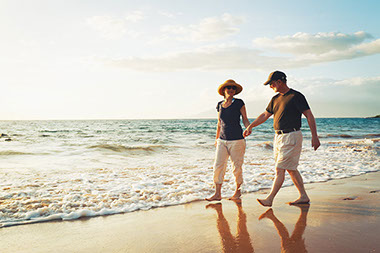 Image of couple walking along the beach.