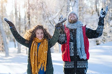 Couple throwing snow up in the air. Couple throwing snow up in the air.