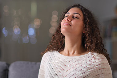 Women taking deep breaths.