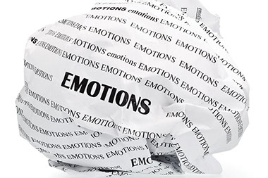 Image of paper balled up with the word 'Emotions' repeated.