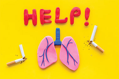 The word "Help" spelled out in clay, as well as lungs and cigarettes.