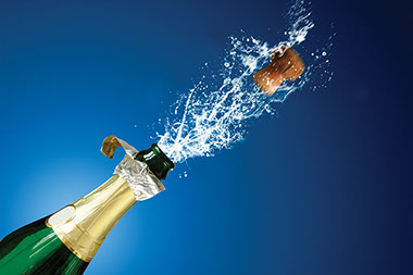 Image of cork popping from a champagne bottle.