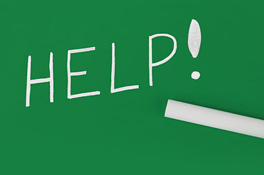 How to recognized and report abuse. Image of the word "Help" spelled out on a green chalk board.