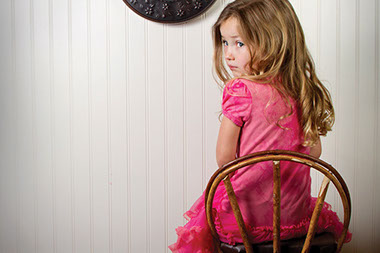 Image of little girl sitting in a time out.