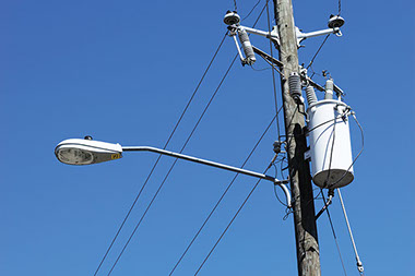 Image of a telephone poll and power lines.
