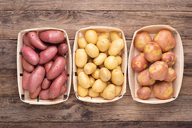 Three baskets filled with potatoes. Three baskets filled with potatoes.