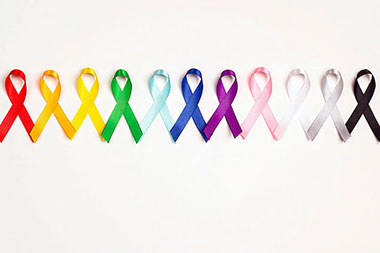 A line of different color ribbons to represent different cancer awareness.