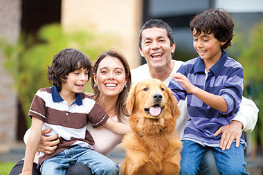 Image of Hispanic family with a pet dog.
