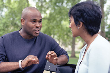 Image of 2 people talking.