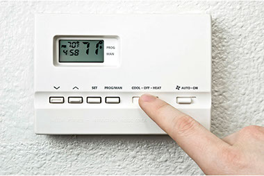 Image of thermostat being set at 71 degrees.