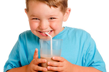 Image of young boy drinking chocolate milk.