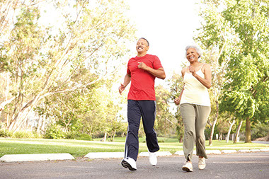 Image of older couple on a brisk walk.